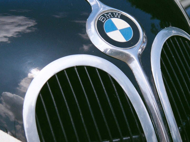 Nahaufnahme eines Kühlergrills mit BMW-Plakette