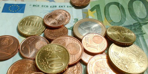 Nahaufnahme verschiedener Euro-Gelscheine und -Münzen.